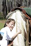 boy hugging a horse