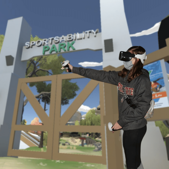woman using VR with the VR SportsAbility Park in background